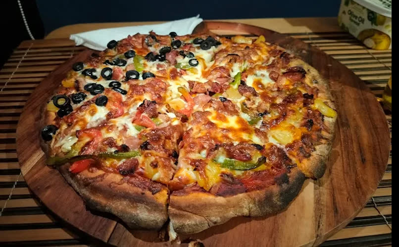 A homemade pizza on a wooden board
